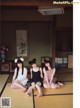 A group of three young women sitting on a tatami mat.