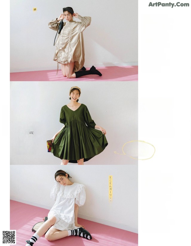 A woman in a green dress sitting on a pink floor.